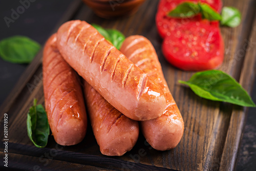 Grilled sausage with tomatoes, basil salad and red onions. BBQ menu.