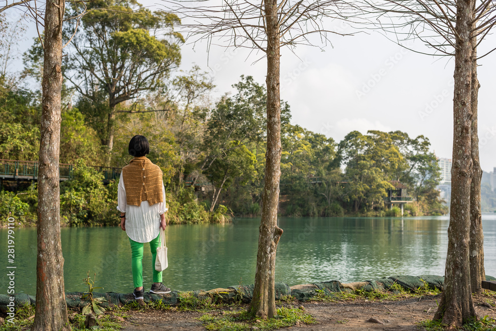 traveling Asian woman stand near the lake traveling Asian woman stand near the lake