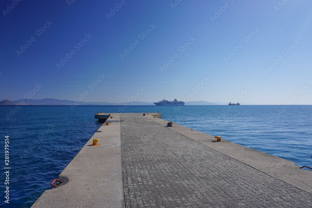 Kos, Greece: View of a cruise ship and the coast of Turkey, from the harbor of Kos, an island in the Dodecanese chain in the Aegean Sea.