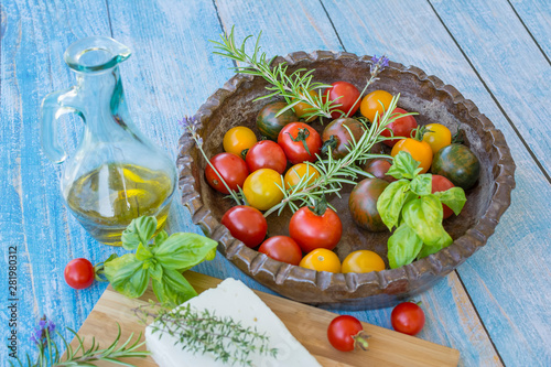 Display of freshly picked heirloom tomatoes with a variety of fresh herbs, Feta Cheese and Olive Oil 