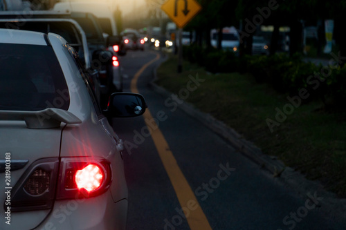 Blurred image of cars on the road with light break at in evening. Arranged in a curve.