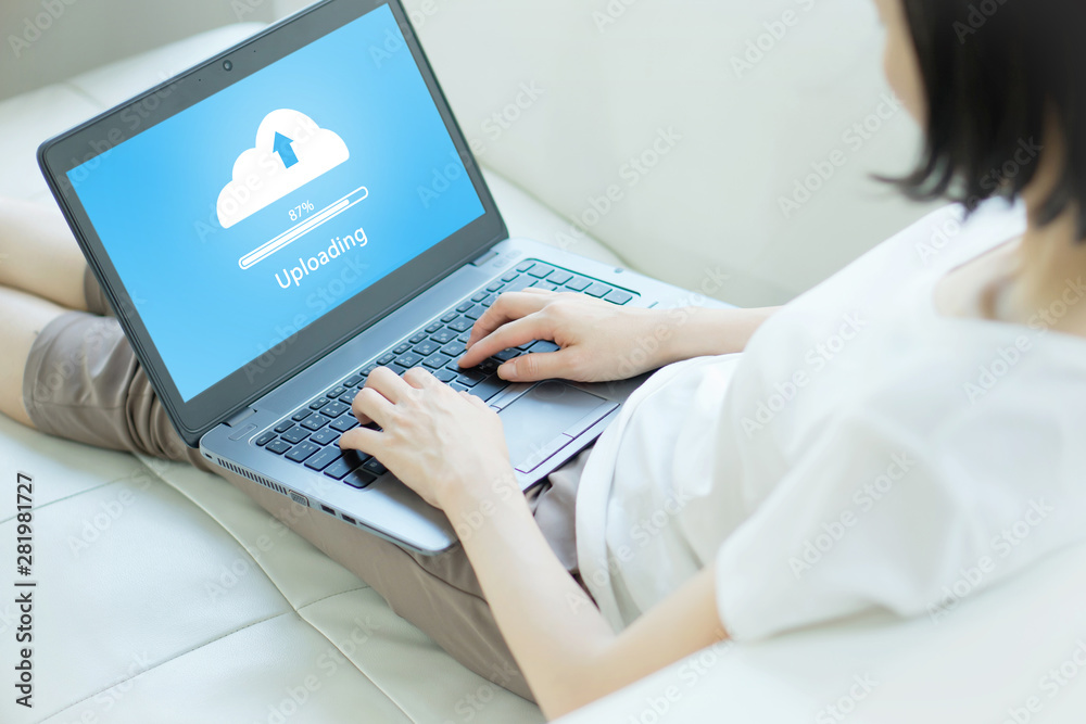 Woman trying to Cloud uploading on laptop Woman trying to Cloud uploading on laptop