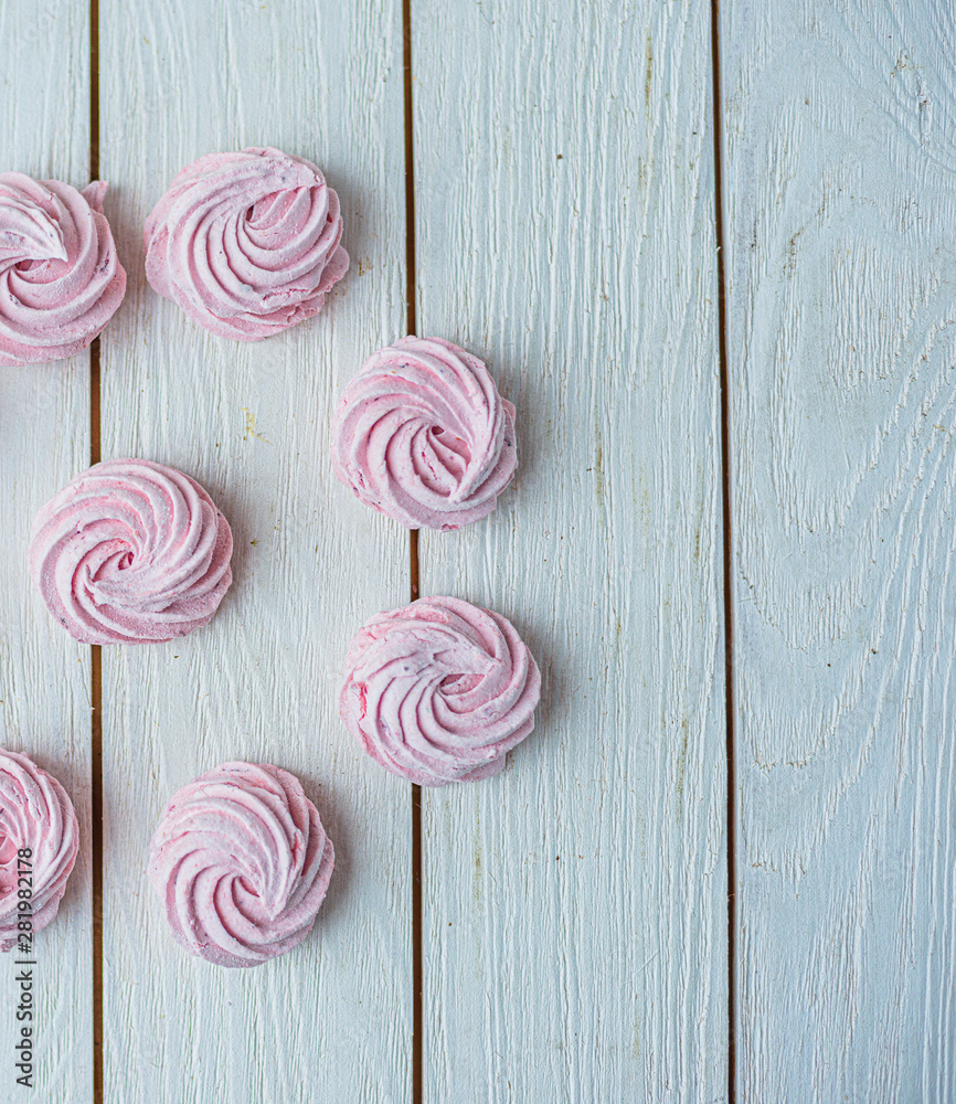 Zephyr lined in a circle on a white background. Flat lay. Top view. Pink sweet homemade zephyr or marshmallow. Colorful meringues on white. top view dessert image. Zephyr lined in a circle on a white background. Flat lay. Top view. Pink sweet homemade zephyr or marshmallow. Colorful meringues on white. top view dessert image.