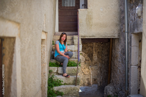 Young woman on the stairs of a old Croatian city.