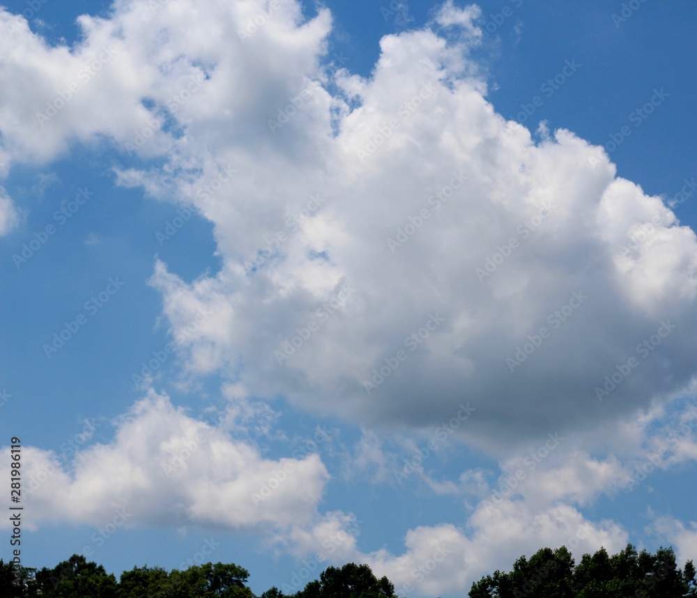 The large white clouds in the bright blue sky. The large white clouds in the bright blue sky.