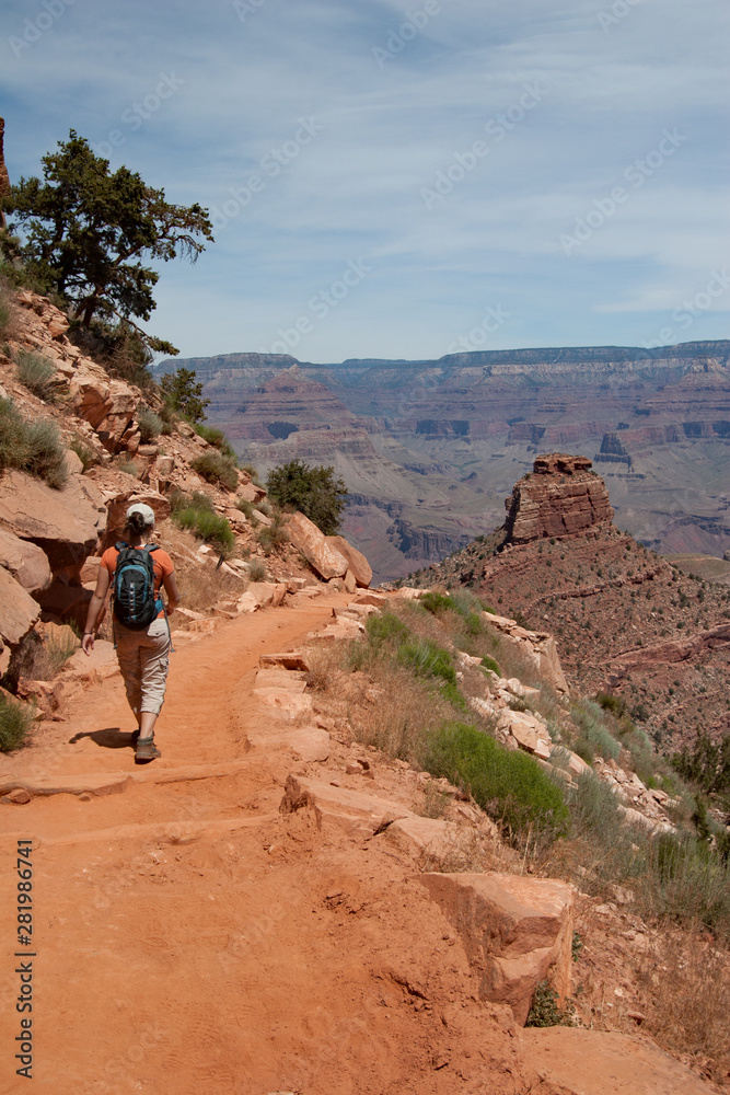 Young woman hiking on South Kaibab Trail in Grand Canyon National Park South Rim, Arizona on sunny summer afternoon.
