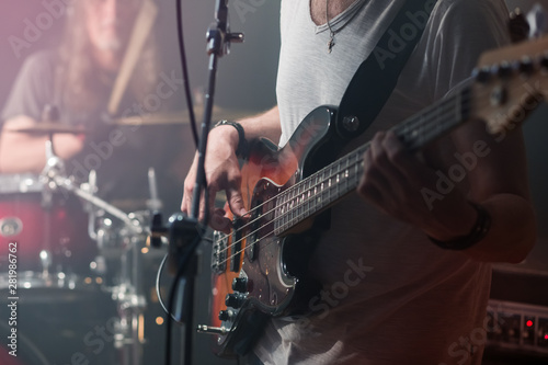 The guitarist plays the electric guitar close-up during the concert.