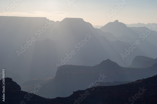 Sun rays at sunrise from Mather Point on South Rim of Grand Canyon National Park, Arizona in summer.