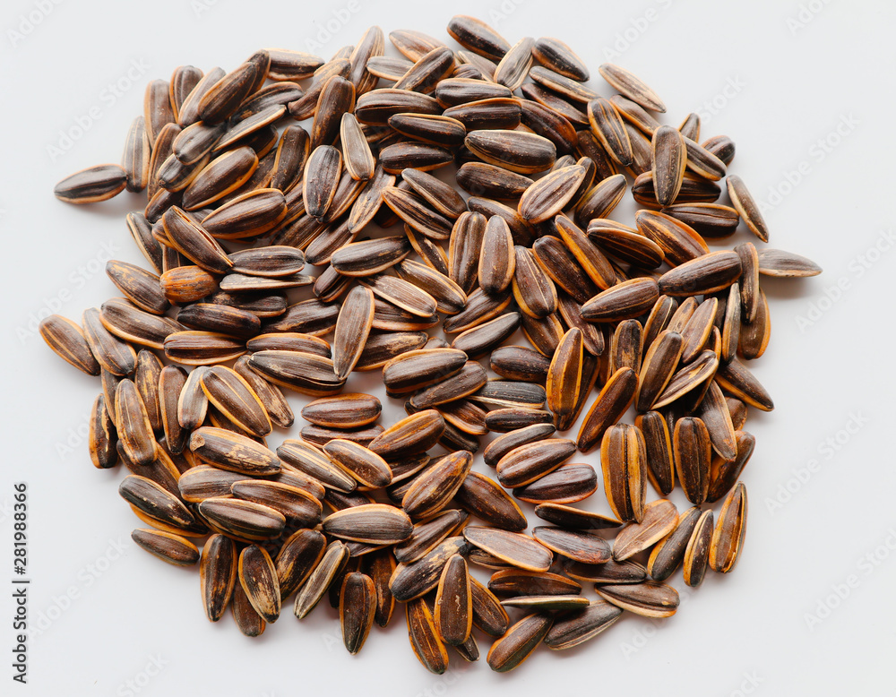 Abstract close up sunflower seeds on the white isolated background and wallpaper Abstract close up sunflower seeds on the white isolated background and wallpaper