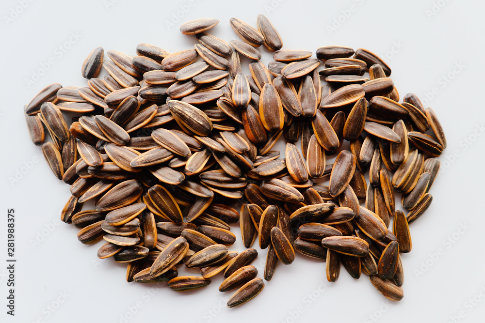 Abstract close up sunflower seeds on the white isolated background and wallpaper Abstract close up sunflower seeds on the white isolated background and wallpaper