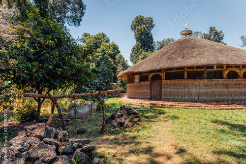 The hut shape UNESCO Monastery Azwa Maryam, church dedicated for the memorial of saint Merry, Bahir Dar, lake Tana Ethiopia. in front of church is stone bell photo