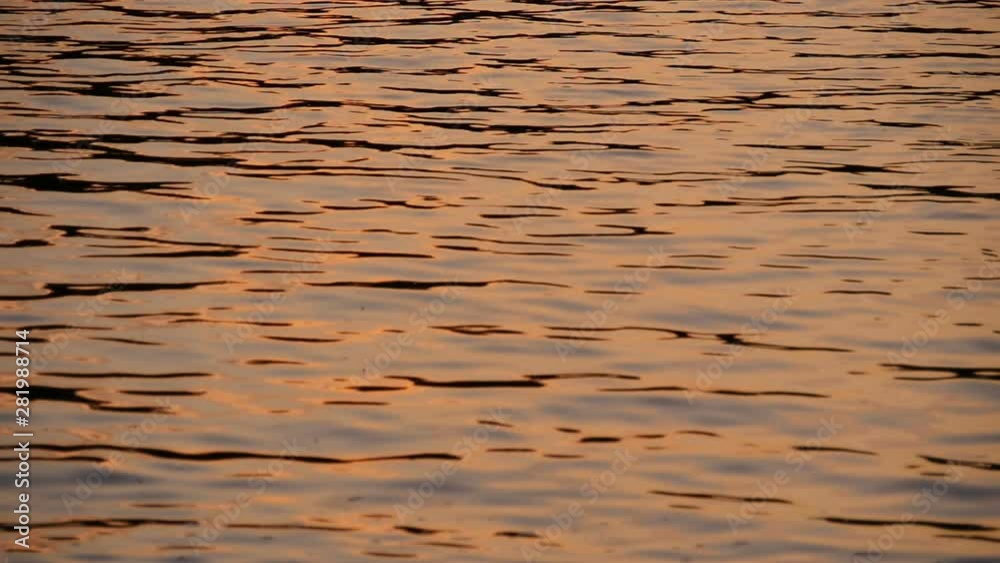 golden glare on the water from the setting sun slow motion golden glare on the water from the setting sun slow motion