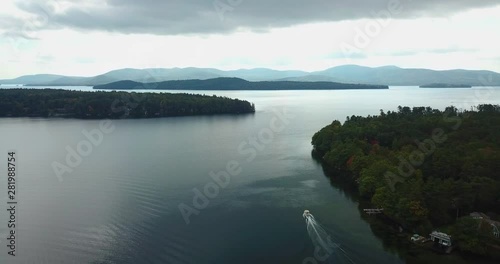 Aerial Lake in Autumn. Follow a boat on movement. Landscape Scenery