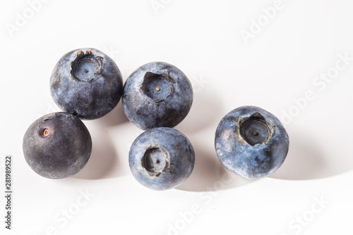 Many red and white berry.Good tasting blueberries with full of healthy vitamins..A good vegan meal. Set of tasty blueberries on white background, closeup.