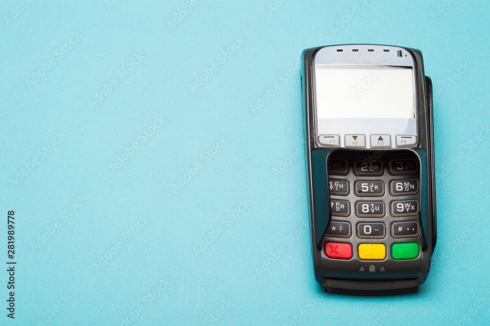 Credit card terminal on blue background. Close up of merchant payment device, card machine. Credit card terminal on blue background. Close up of merchant payment device, card machine.