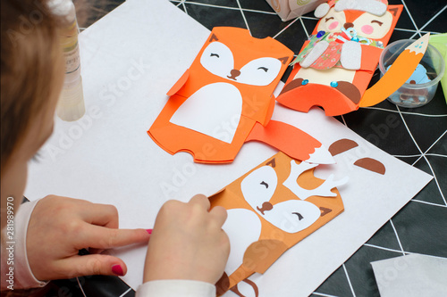 Children make Christmas crafts. Child art project. Kids hands makes paper craf. Christmas crafts for children.DIY concept.