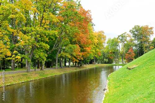 Pond with a forest and hill against sky