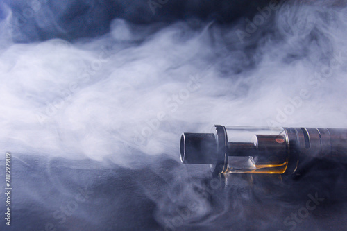 Abstract image of an electronic cigarette in smoke. copy space. The concept of the dangers of smoking, an alternative to cigarettes, bad habits.