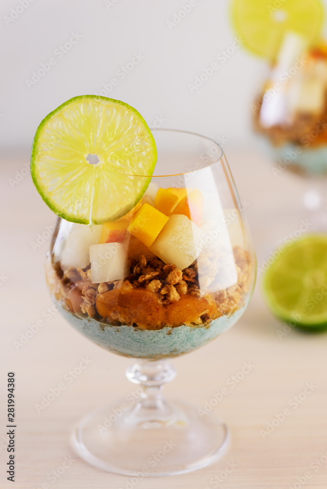 Garnola with yogurt, melon, peach and spirulina in a glass. Garnola with yogurt, melon, peach and spirulina in a glass.