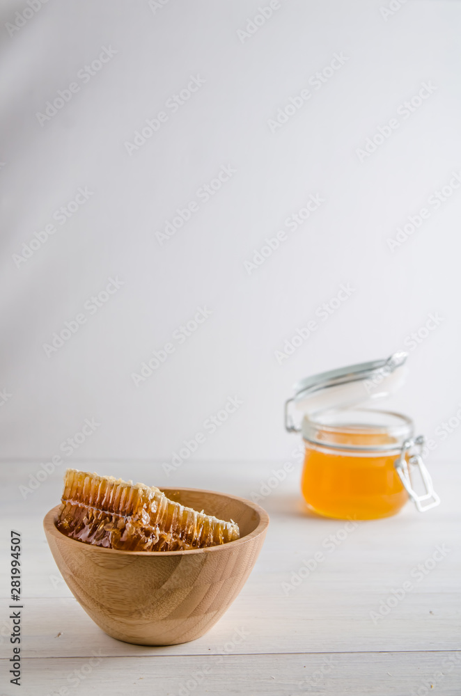 fresh honey and honeyons on a white background with copy space fresh honey and honeyons on a white background with copy space