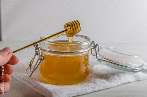 fresh honey drains from spoonfuls for honey
