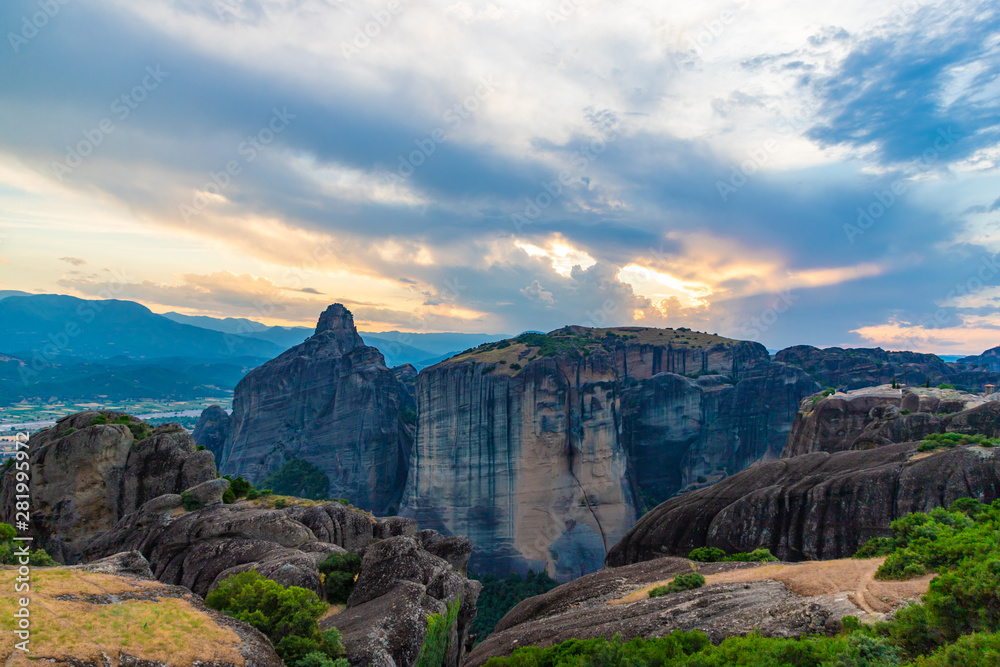 Wonderful view of the rocks of Meteora, Greece. Mysterious Sunny evening with colorful sky, during sunset. Awesome Nature Landscape. Amazing Greece. Popular travel locations