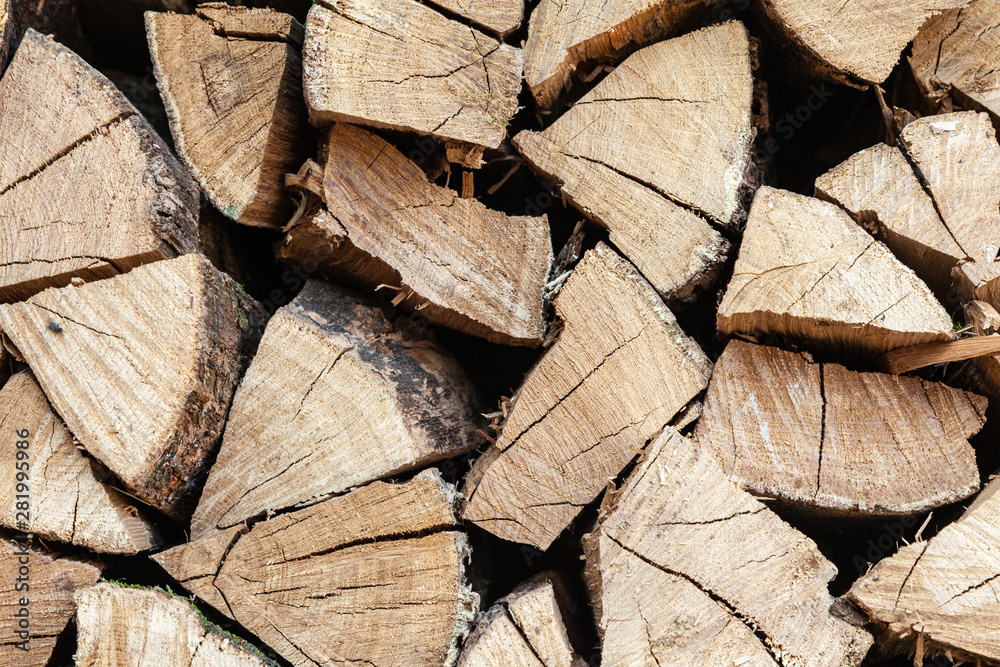 Close-up of dried wood for burning bonfire. Background of dry chopped wood folded for the fireplace. A pile of firewood for heating a house. Close-up of dried wood for burning bonfire. Background of dry chopped wood folded for the fireplace. A pile of firewood for heating a house.