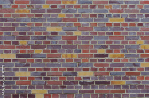 Texture of an old, weathered and colorful brick wall