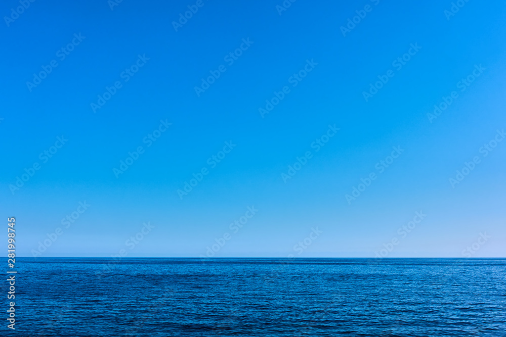 Seascape with sea horizon and blue sky