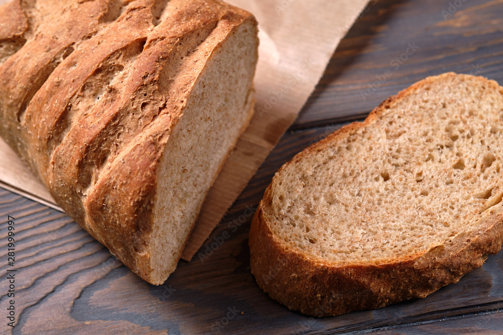 Bread with bran, sliced on an wooden table, selective focus. Homemade bread