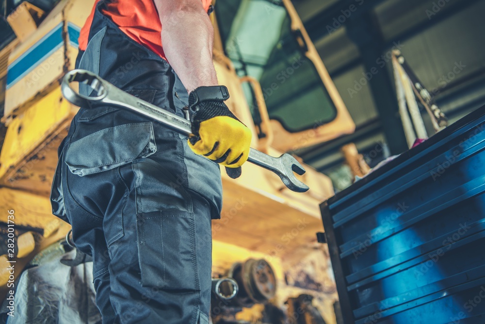 Men Fixing Heavy Machinery Men Fixing Heavy Machinery