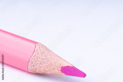 close up of pink pencil on white background .