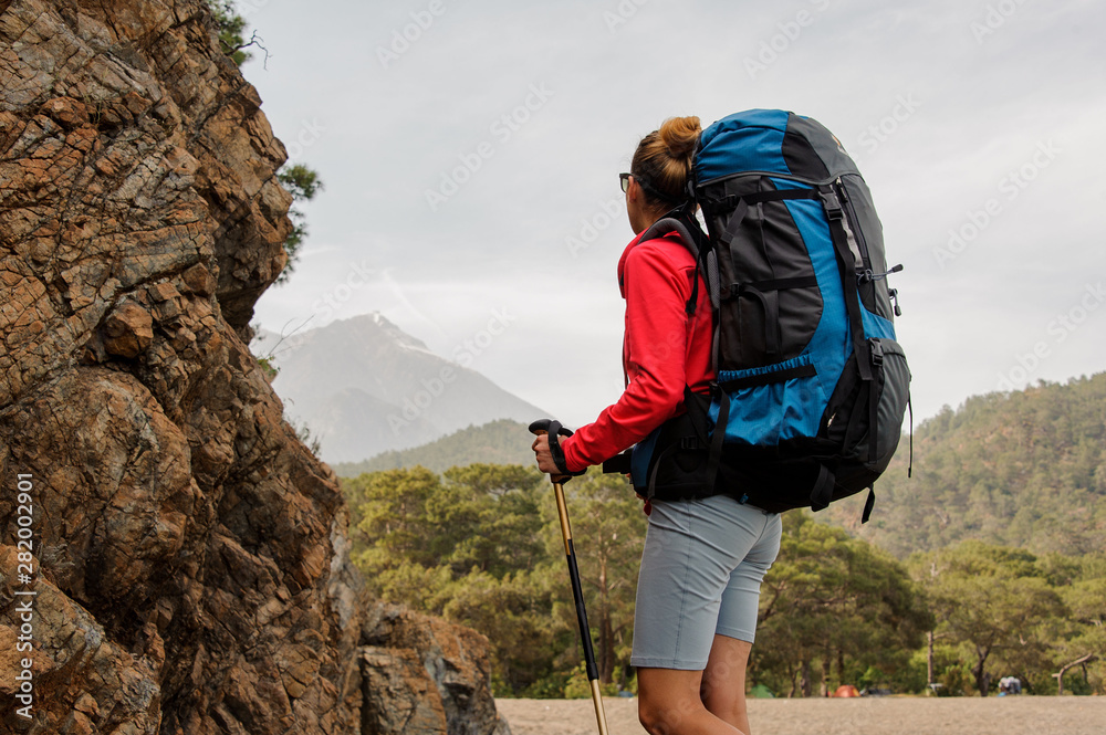 Female traveller looks back on hills in Turkey