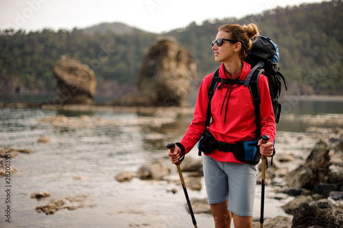 Portrait of trekking girl with hiking equipment