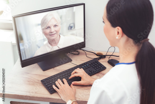 Doctor and senior woman patient, telehealth photo