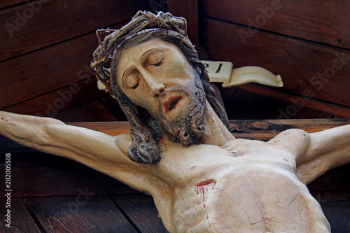 crocifisso in legno dipinto presso la chiesa parrocchiale di San Zeno a Naturno photo