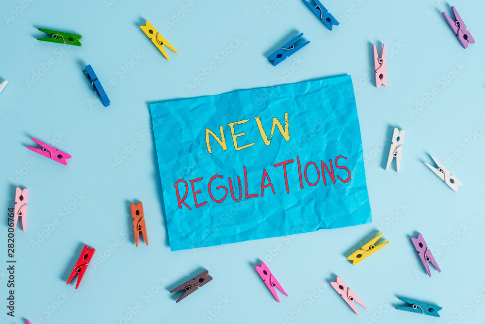 Word writing text New Regulations question. Business photo showcasing rules made government order to control way something is done Colored clothespin rectangle shaped reminder paper light blue Word writing text New Regulations question. Business photo showcasing rules made government order to control way something is done Colored clothespin rectangle shaped reminder paper light blue