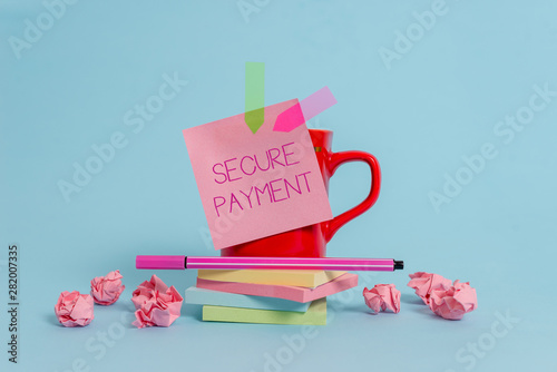 Writing note showing Secure Payment. Business concept for Security of Payment refers to ensure of paid even in dispute Coffee cup pen note banners stacked pads paper balls pastel background