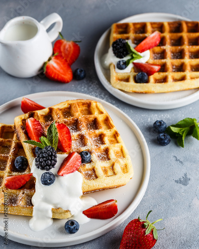 Brussels waffles with sour cream, strawberries, blueberries and blackberries