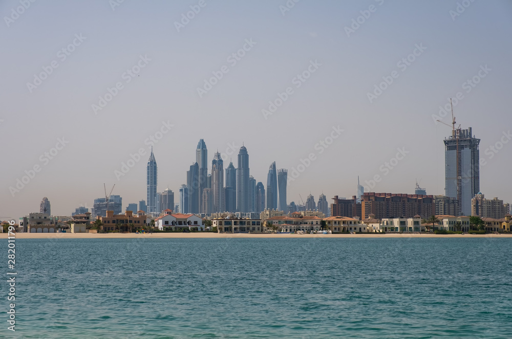 DUBAI, UAE - may 2019. View of various skyscrapers including Cayan Tower in Dubai Marina with stunning turquoise waters as foreground