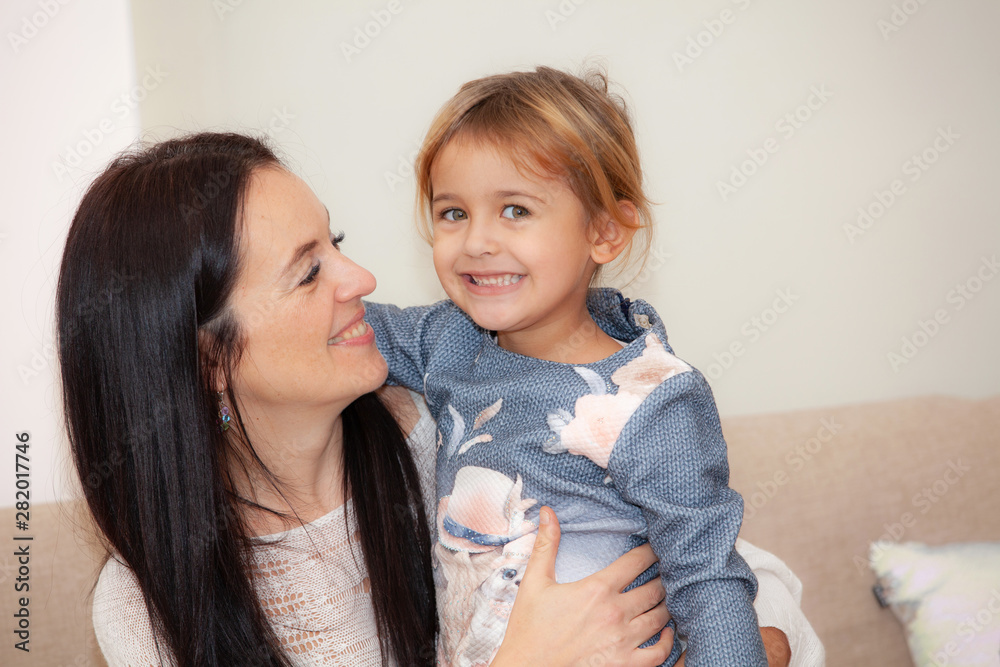 happy mother with her daughter in the room