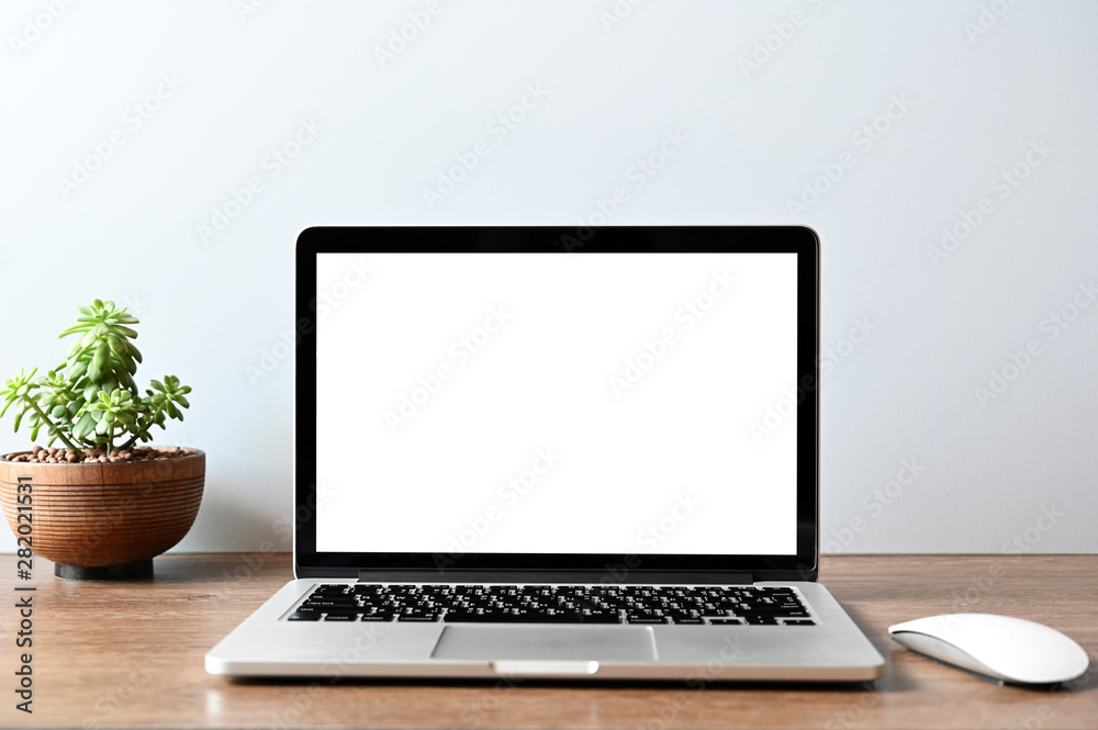 blank screen Modern laptop computer with mouse,Smart phone and Succulent on wood table in office view backgrounds blank screen Modern laptop computer with mouse,Smart phone and Succulent on wood table in office view backgrounds