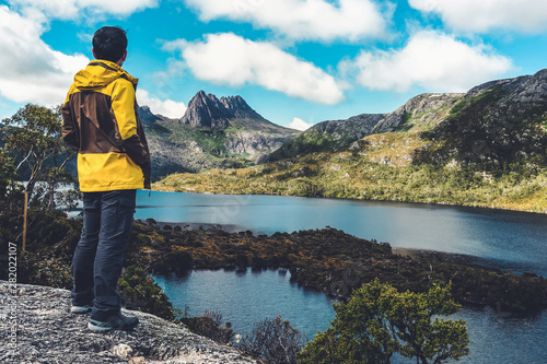 Traveller man explore landscape of Marions lookout trail in Cradle Mountain National Park in Tasmania, Australia. Summer activity and people adventure. photo