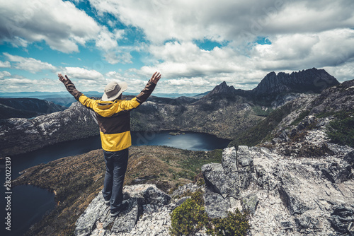 Traveller man explore landscape of Marions lookout trail in Cradle Mountain National Park in Tasmania, Australia. Summer activity and people adventure. photo