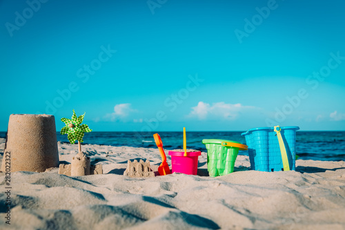 sand toys on tropical beach, kids play on sea vacation
