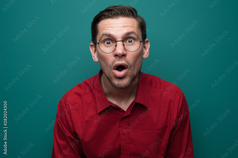 Portrait of shocked surprised young man in glasses Portrait of shocked surprised young man in glasses