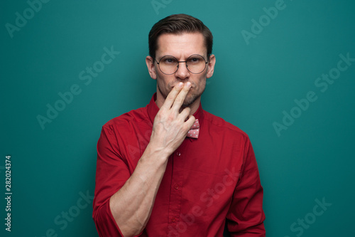 Portrait of a serious doubting man in glasses