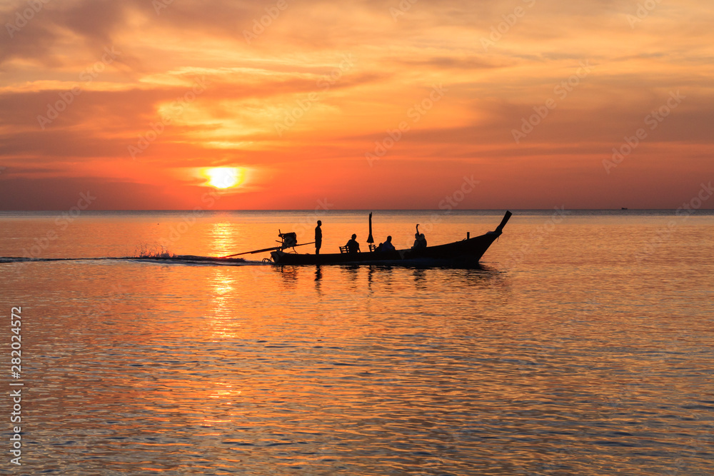 Long tail boat at sunset,