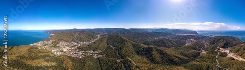 mountains near the city of Tuapse and the resort village of Agoy on the Black Sea coast - aerial drone large panorama view from a mountain pass in summer sunny day