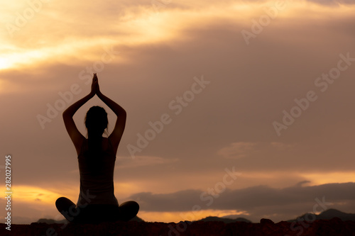 Fototapeta Naklejka Na Ścianę i Meble -  silhouette fitness girl practicing yoga on mountain